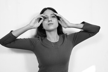 Woman touch head by hands. Face mood reaction expression. monochromic colors