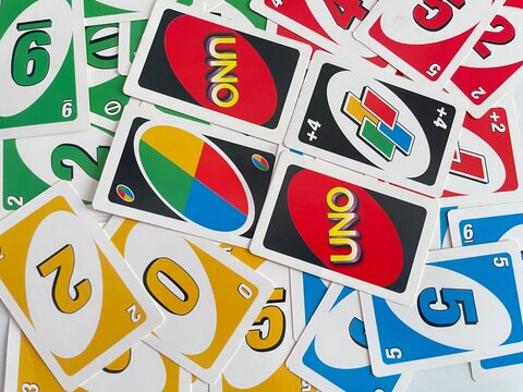 Top view uno card game cards scattered all over the frame with two uno text placed in the middle. This game card is suitable for all generations of players, on April 29, 2025 in Jakarta, Indonesia