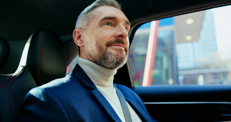 Thinking, travel and business man in taxi for transportation, conference trip or reflection. Private chauffeur service, commute and vision with mature person in car for tourism, professional or drive © BuyOutFelix03/peopleimages.com