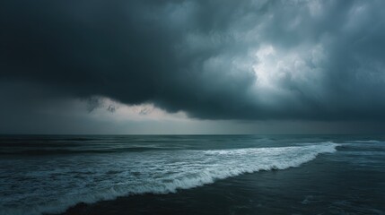 Dark, heavy storm clouds gather over turbulent ocean waves. Powerful water crashes towards the viewer under a dramatic, moody sky.