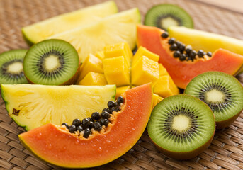 Tropical Texture Quartet — Mango, Kiwi, Pineapple, and Papaya on Woven Mat
