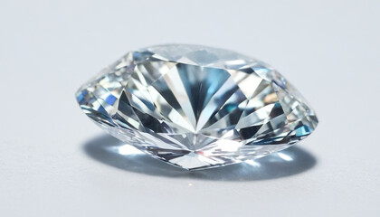 A stunning diamond lies on a smooth surface, reflecting light in various colors, emphasizing its meticulous cut and clarity. This elegant gem captures the essence of luxury