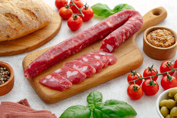 smoked sausage on a wooden board basil and mustard