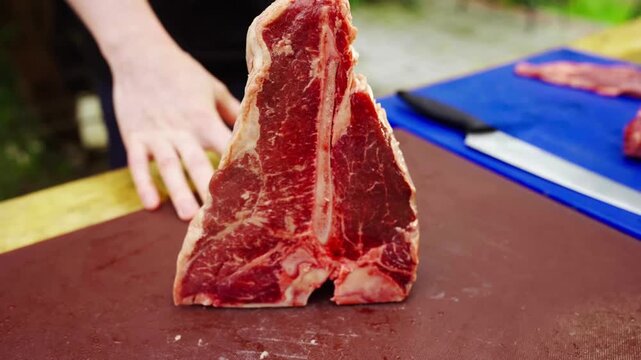 Expert handling of a large t-bone steak