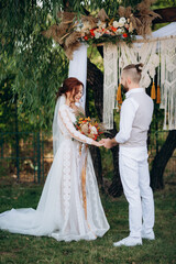 Fototapeta premium wedding ceremony of a young couple in love on a green meadow