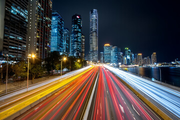 Close up, A neon city skyline with light trails of cars at night