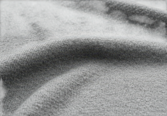 Closeup texture of gray fabric with soft folds and shadows isolated on transparent background