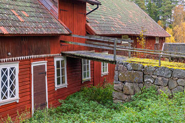 Old wooden red barn with a bridge to the loft