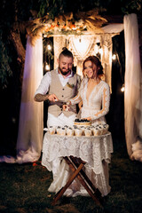 newlyweds happily cut and taste the wedding cake