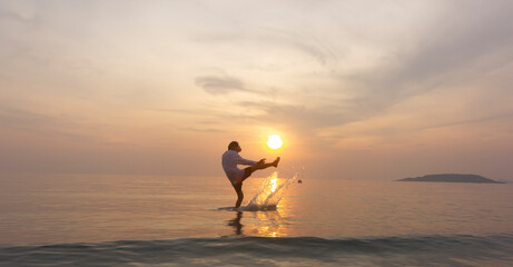 sunset and sky with silhouette of man kick the sea water with happy and relax time