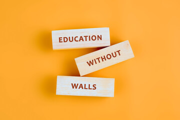 Naklejka premium Copy space; Concept words EDUCATION WITHOUT WALLS assembled from blocks on orange background, top view