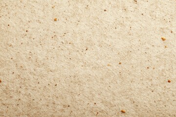 Close-up view of a light beige, granular powder with small, scattered specks