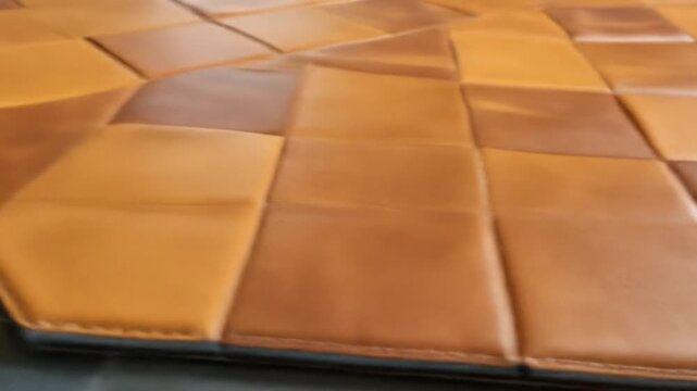 Close Up of Square Brown Leather Tile Pattern with Stitching and Rustic Texture Decorative Design Luxury Material Panel
