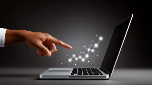 Finger points towards laptop screen showing increasing trend line made of sparkles. Dark background focusing on technology and data analysis