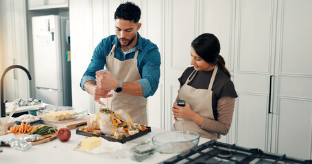 Cooking, smile and couple in kitchen with turkey for meal prep, supper and festive lunch. Thanksgiving, food and man with woman with ingredients, recipe and meat for nutrition, dish or dinner party