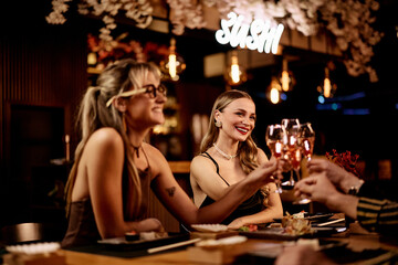 Friends Enjoying Drinks and Sushi at a Cozy Upscale Restaurant