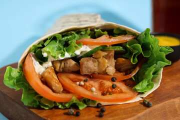 Tasty doner kebab on wooden board,  closeup