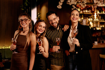 Group of Cheerful Friends Enjoying Wine Together at a Stylish Bar