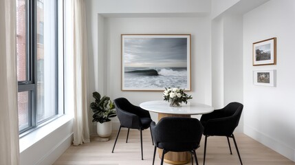 Minimalist dining area with a round table, four sleek chairs, white walls, and a single framed art piece for a clean aesthetic