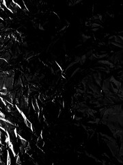 Transparent cellophane bag against a sleek black background, showcasing its glossy, delicate...