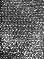 Transparent cellophane bag against a sleek black background, showcasing its glossy, delicate...