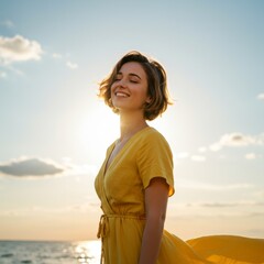 Obraz premium Happy Young Woman in Yellow Dress at Sunset Beach