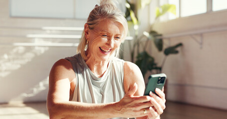 Phone, laugh and old woman in gym for fitness, exercise schedule or information online for health. Mobile, studio and happy senior person check wellness app for pilates, funny meme and reading joke