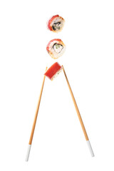 Tasty flying sushi rolls and chopsticks on white background
