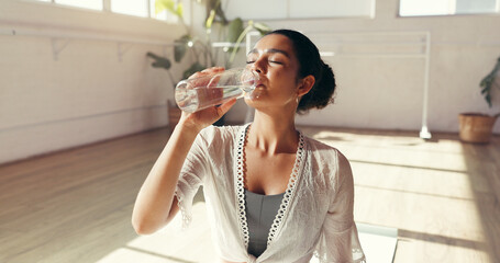 Woman, fitness or yoga with water for hydration, recovery or natural beverage in gym. Female person, yogi or thirst with aqua, mineral liquid or bottle for workout break, rest or drink in health club