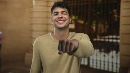 Man uses fist to deliver tap in outdoor scene by young hispanic male greeting salute solidarity.