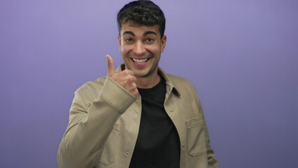 Man counting on fingers in studio; celebration excitement joy.