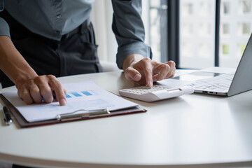 Businessman Calculating Revenue and Planning Business Strategy at Office