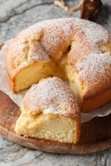 Torta Nua Soft Italian Cake with Custard Cream closeup on the wooden board on the table. Vertical
