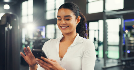 Texting, athlete and woman with smartphone, gym or communication with contact on social media or...