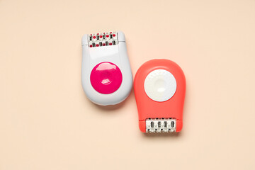 Modern epilators on beige background