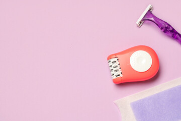 Modern epilator with razor and wax strip on lilac background