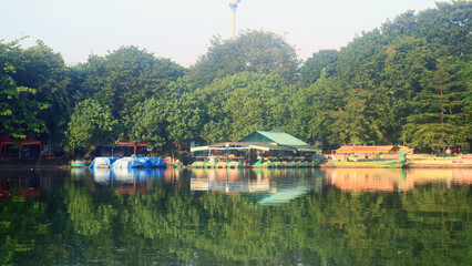 A view of Sunter Lake in the morning in North Jakarta, Indonesia. Green trees and blue sky.    