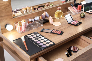 Makeup products on table in dressing room, closeup