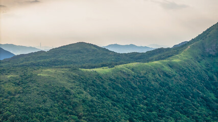 July 5 2025 View of Lush Green Rolling Hills and Distant City Skyline