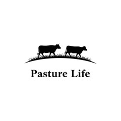Silhouette of two cows walking on a grassy hill. Simple, elegant design.