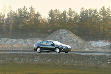 Business-class sedan in motion downtown