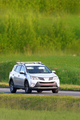 Fototapeta premium Sport utility vehicle driving on country road