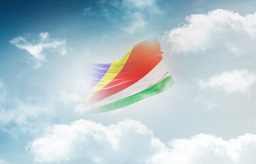 Seychelles flag waving light background hidden in the sky.