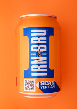 LONDON,UK - MARCH 02, 2025: Original Irn Bru soda soft drink in aluminium tin on orange  background. Top view.
