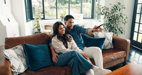 Happy couple, relax or watching tv with remote on sofa for online streaming or subscription in...