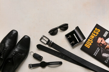 Set of male accessories with shoes, sunglasses and magazine on white background. Top view