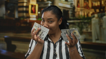 African american woman referee counting money with hands inside church building; temptation greed...