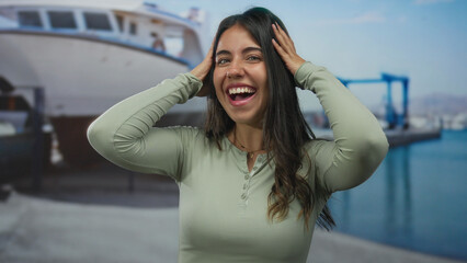 Woman smiling by seaside boat port outdoors young hispanic happy casual hair water
