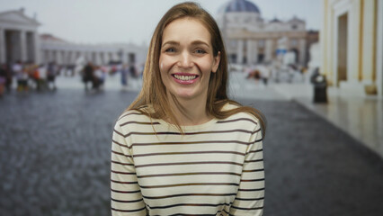 Young caucasian woman talking with open mouth in street outside the vatican building; travel...