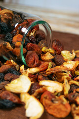 Dried Fruits Spilling from Glass Jar on Table